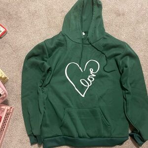 Dark green pull over sweatshirt with a heart
